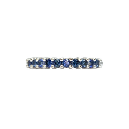 Silver band ring featuring a row of round blue sapphires