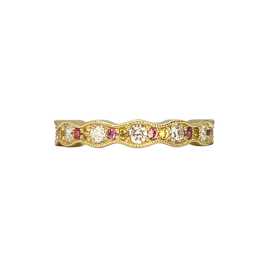 Gold band with alternating round diamonds, pink sapphires, and yellow sapphires, set in a wavy, milgrain-edged design.