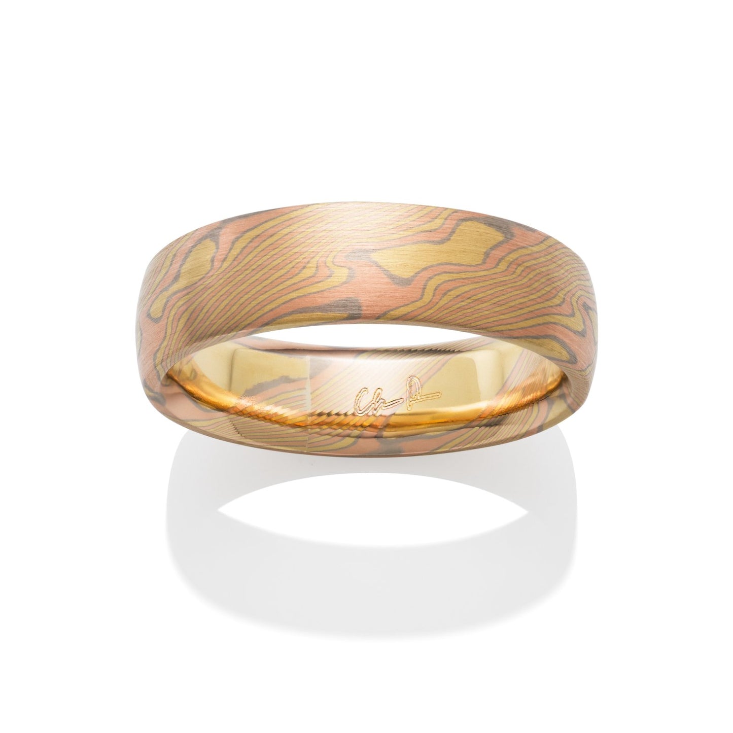 Damascus steel band ring on a white background