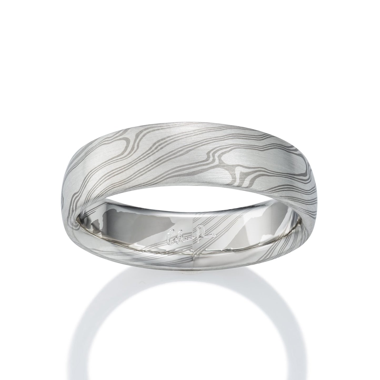 Damascus steel band ring on a white background