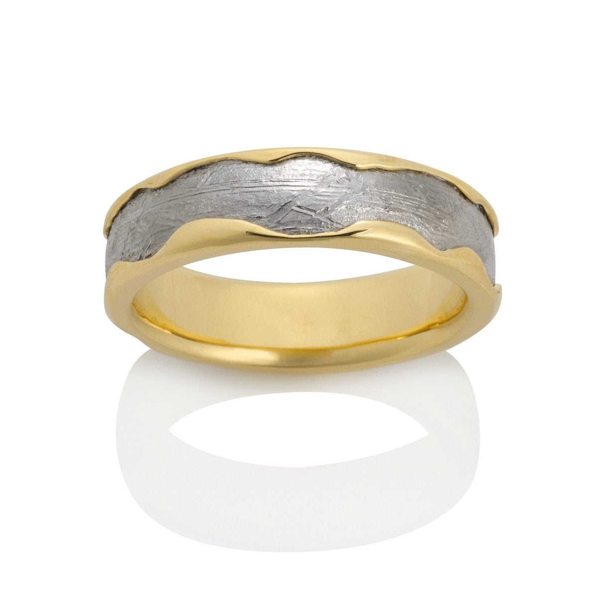 Yellow gold ring with a textured, pattern on a white background