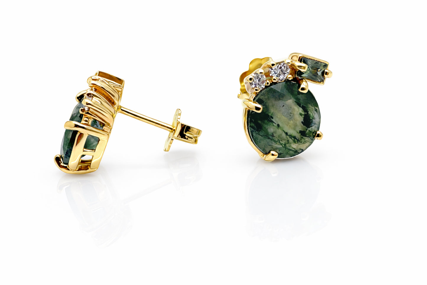 Gold earrings with green gemstones on a white background