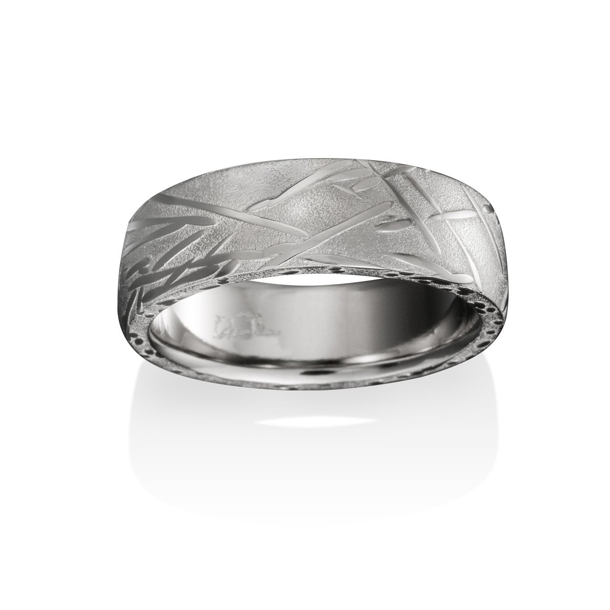 Silver ring with a textured, patterned surface on a white background