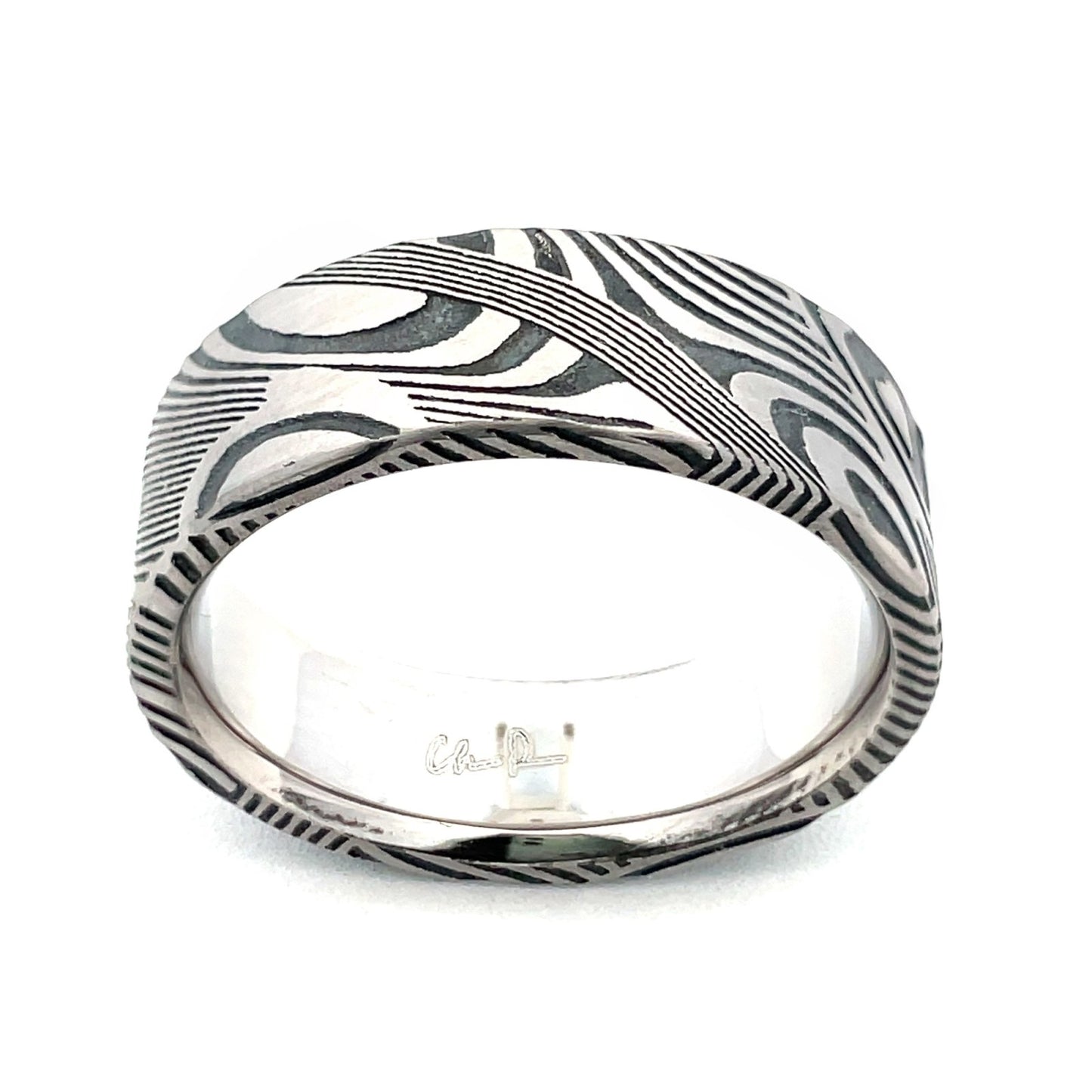 Silver ring with a textured, patterned surface on a white background