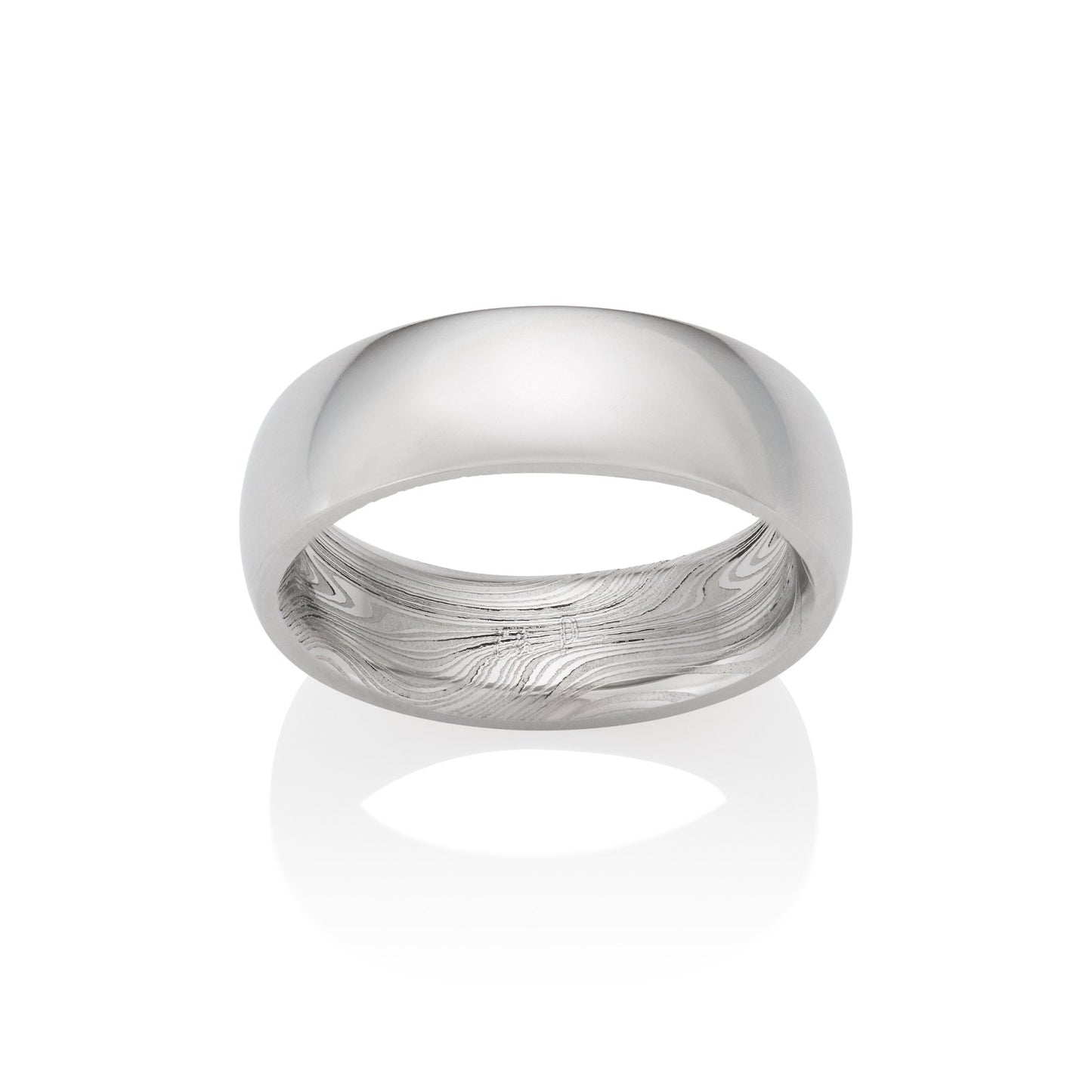 Stainless steel ring with a Damascus steel pattern on the inside, on a white background.