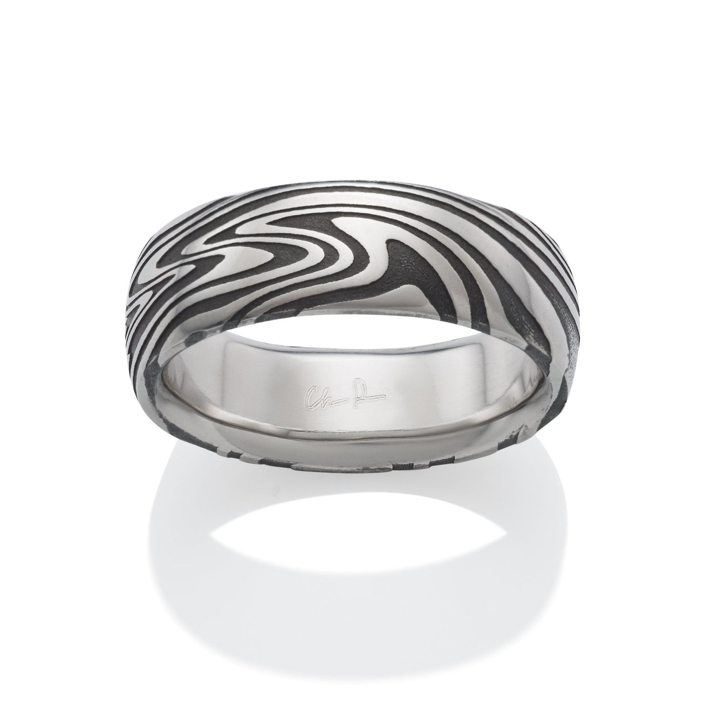 Damascus steel pattern band ring on a white background.
