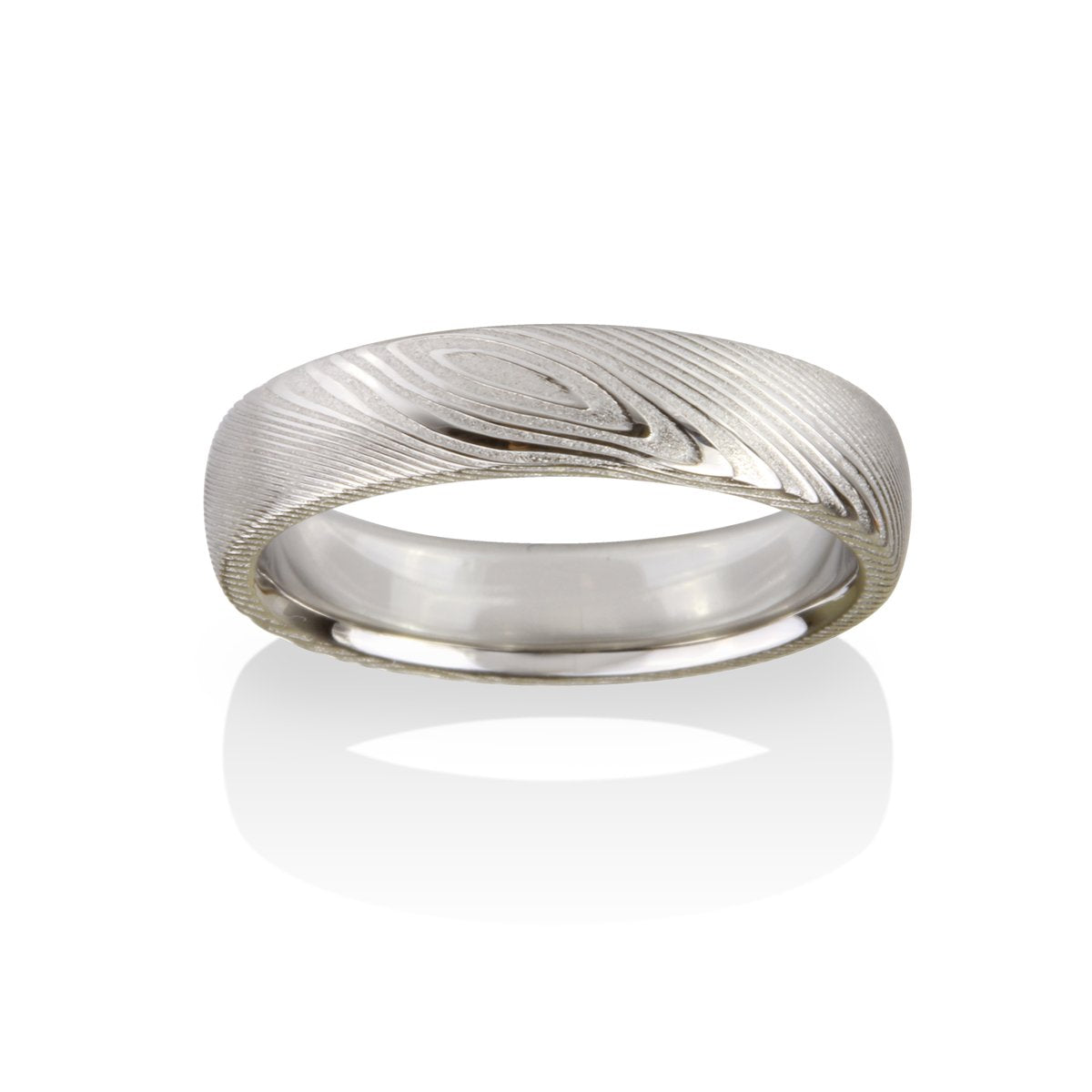Damascus steel pattern band ring on a white background.