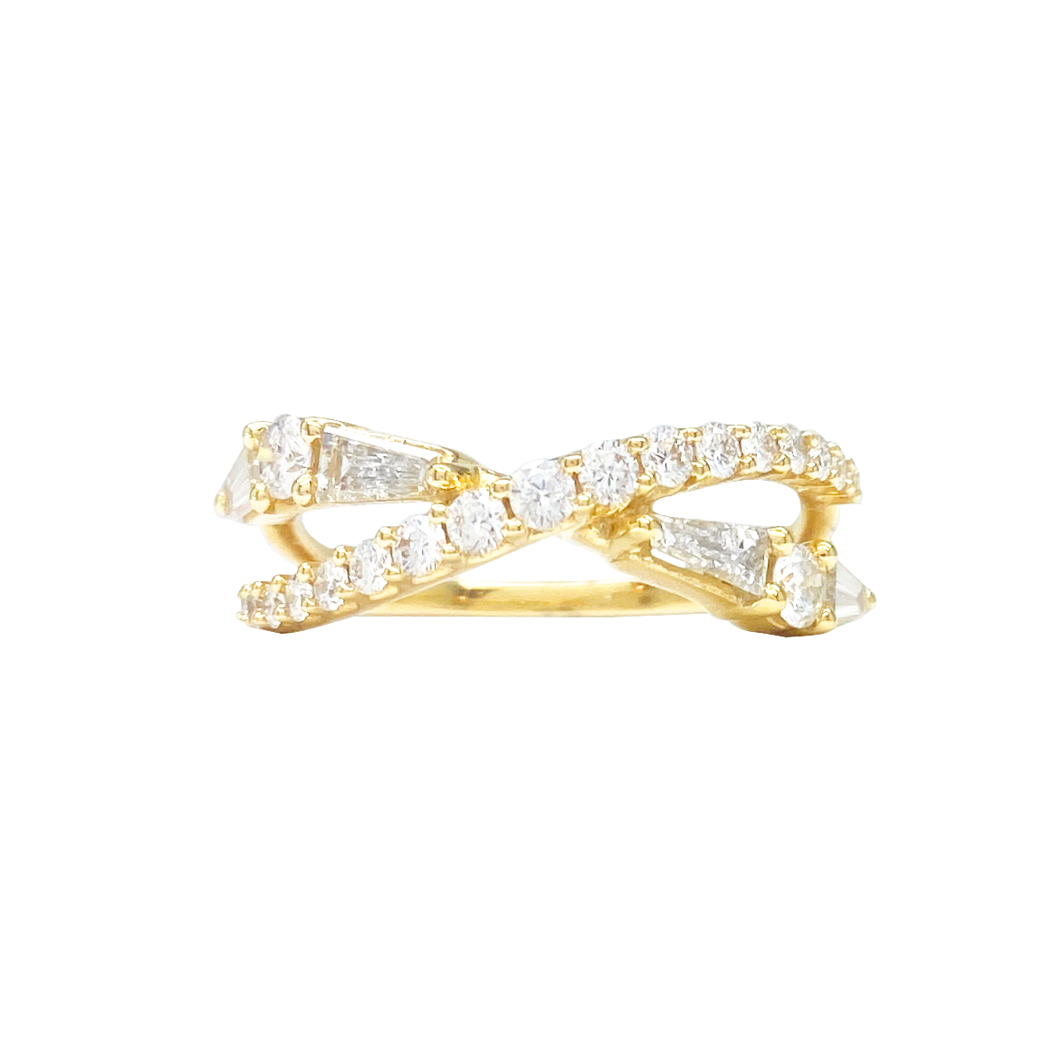 Gold ring with a crisscross design set with baguette and round diamonds. The background is white.