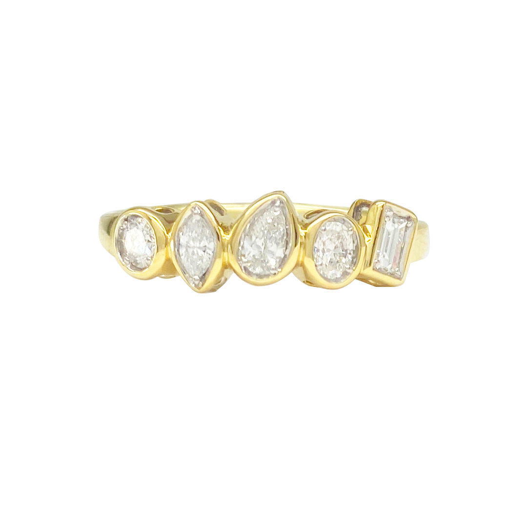 Gold ring with five uniquely cut diamonds of various shapes set horizontally across the band, on a white background.