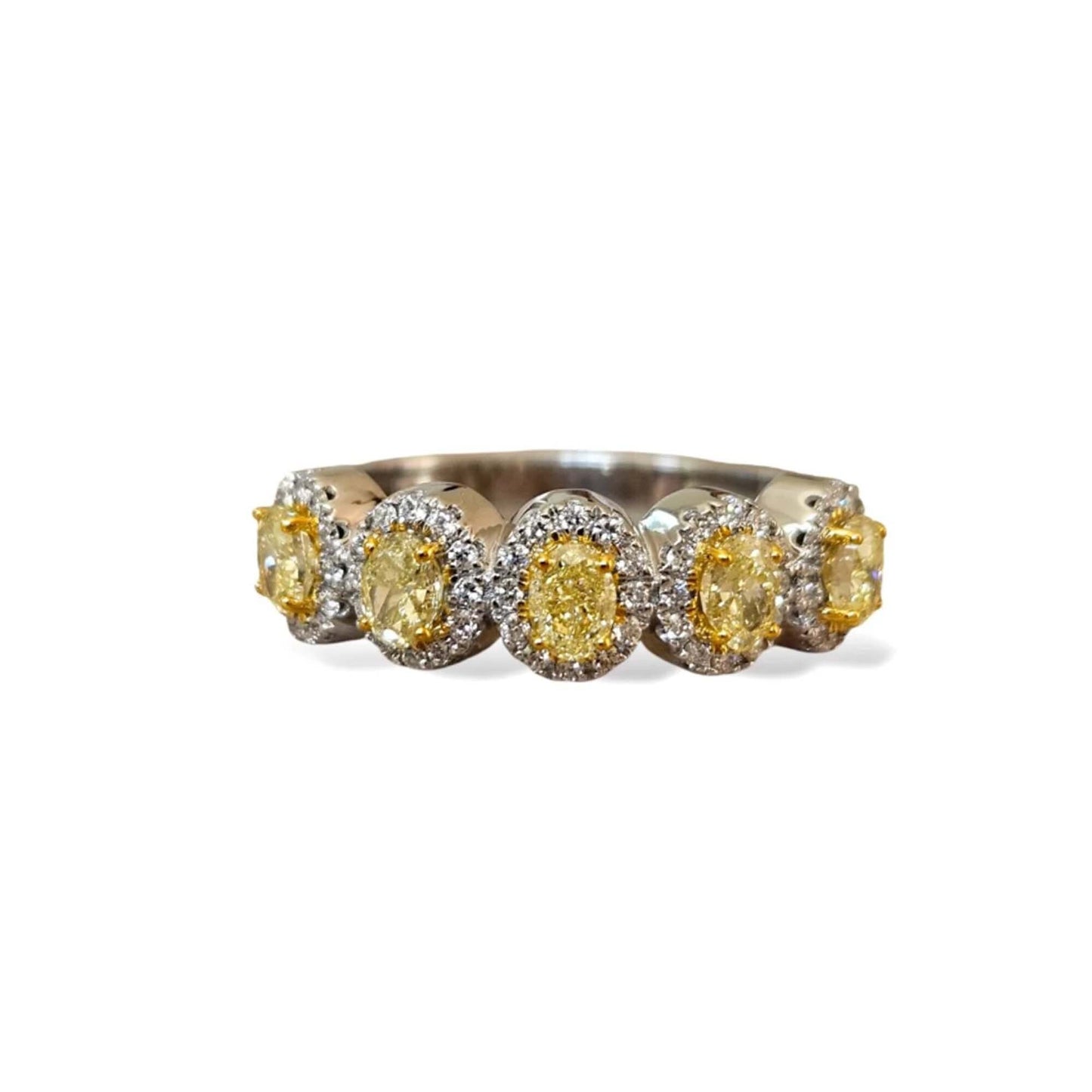 Ring with yellow gemstones on a white background