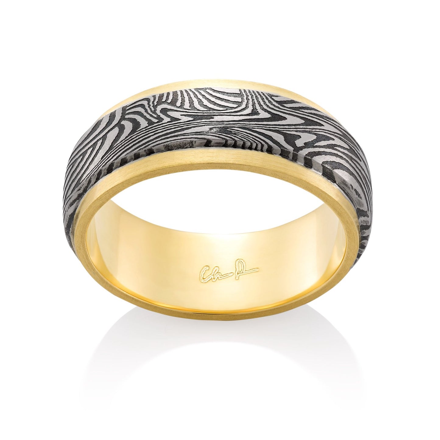 Yellow gold ring with a Damascus steel inlay on a white background