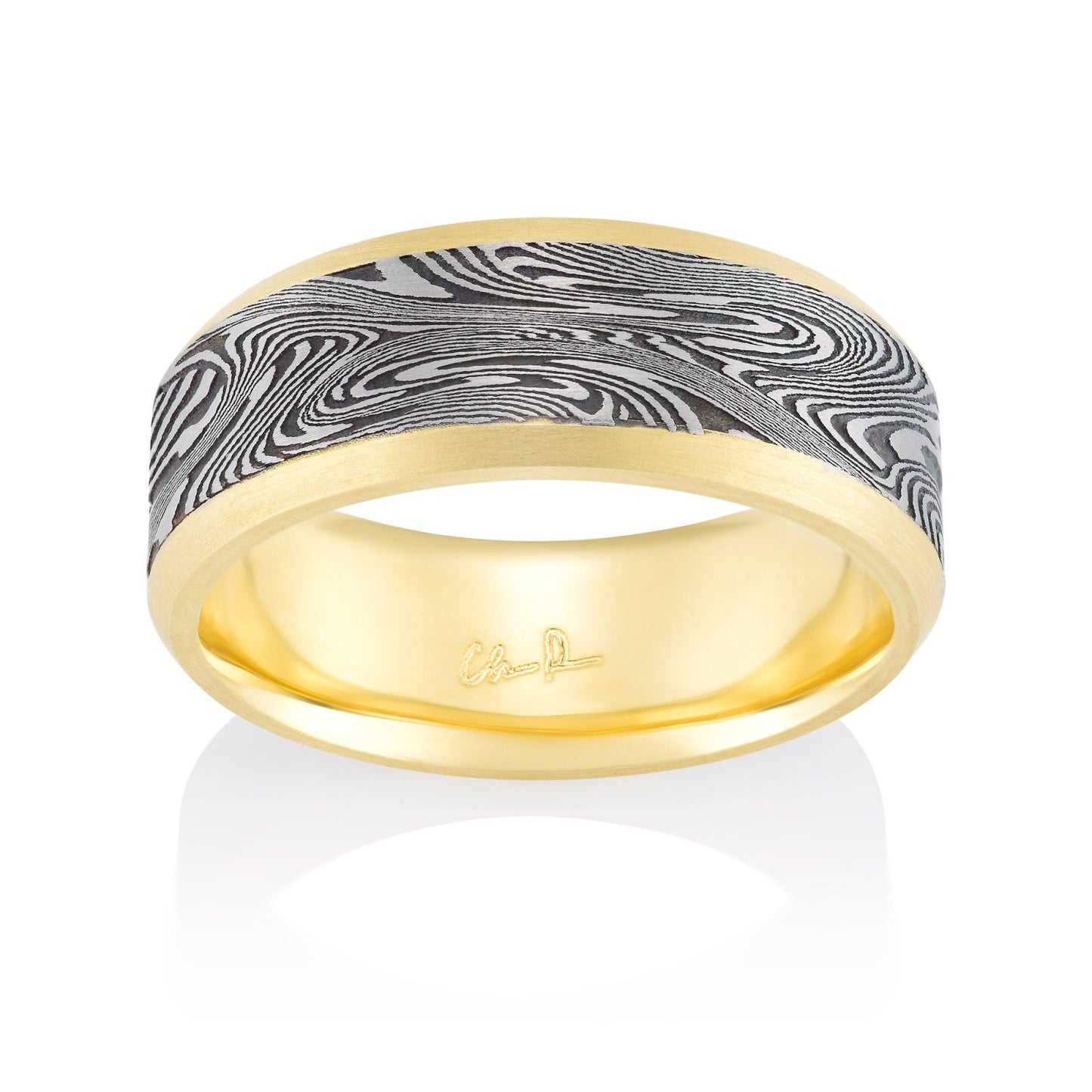 Yellow gold ring with a Damascus steel inlay on a white background