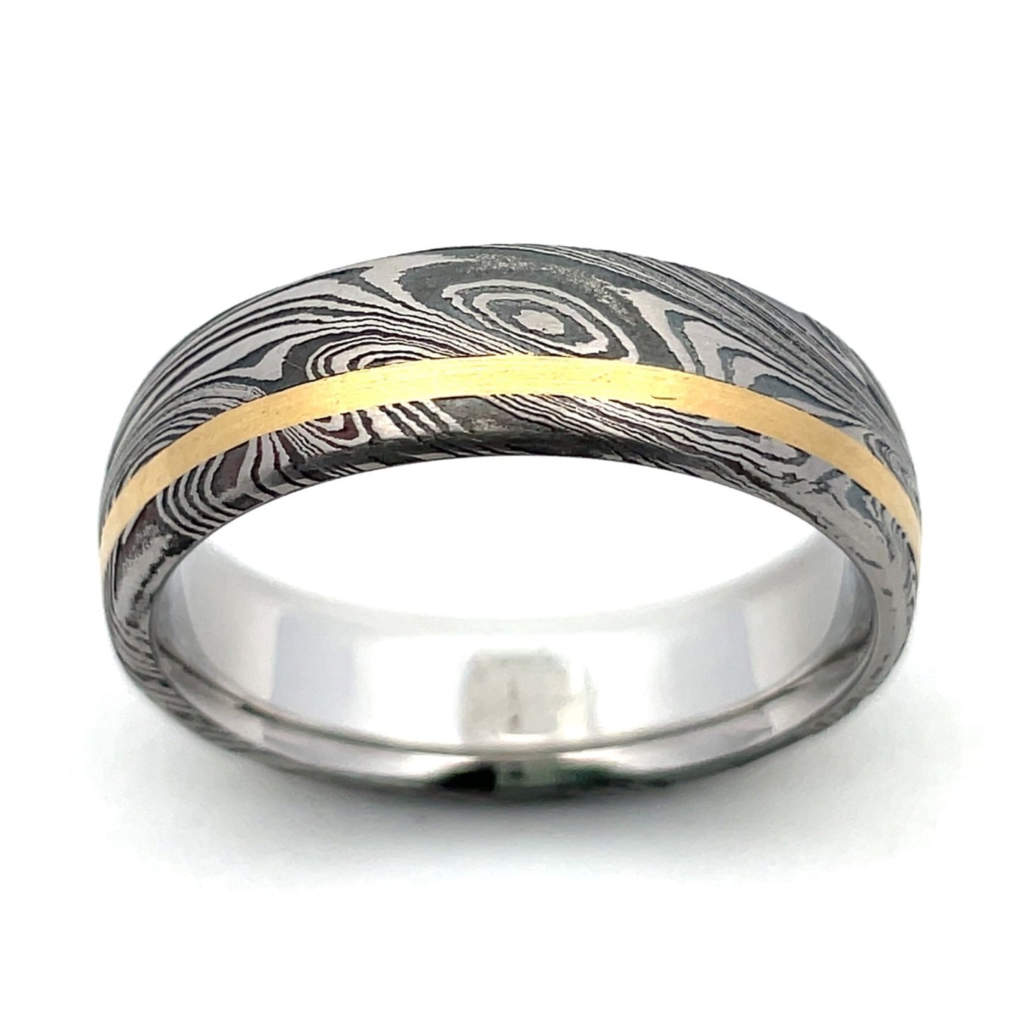 Stainless steel ring with a Damascus steel pattern and gold inlay, on a white background.