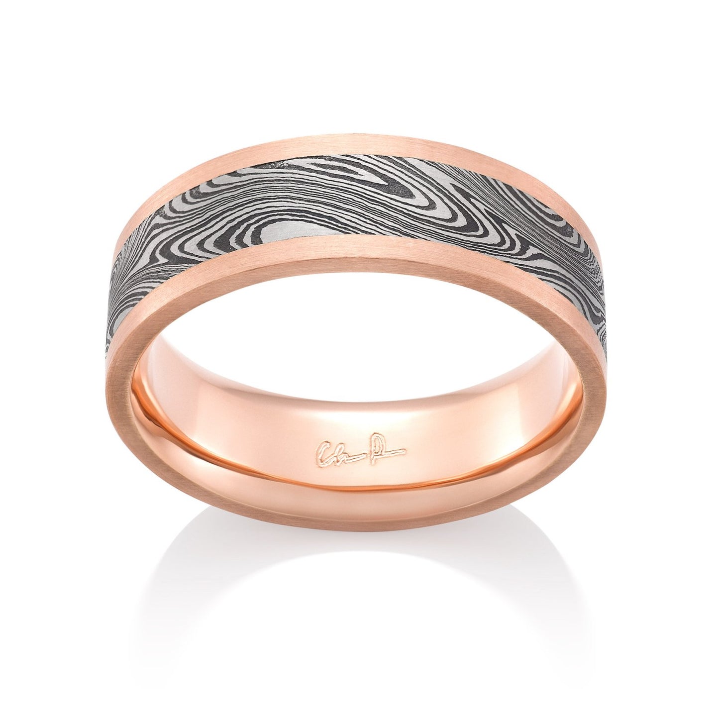 Rose gold ring with a Damascus steel inlay on a white background.