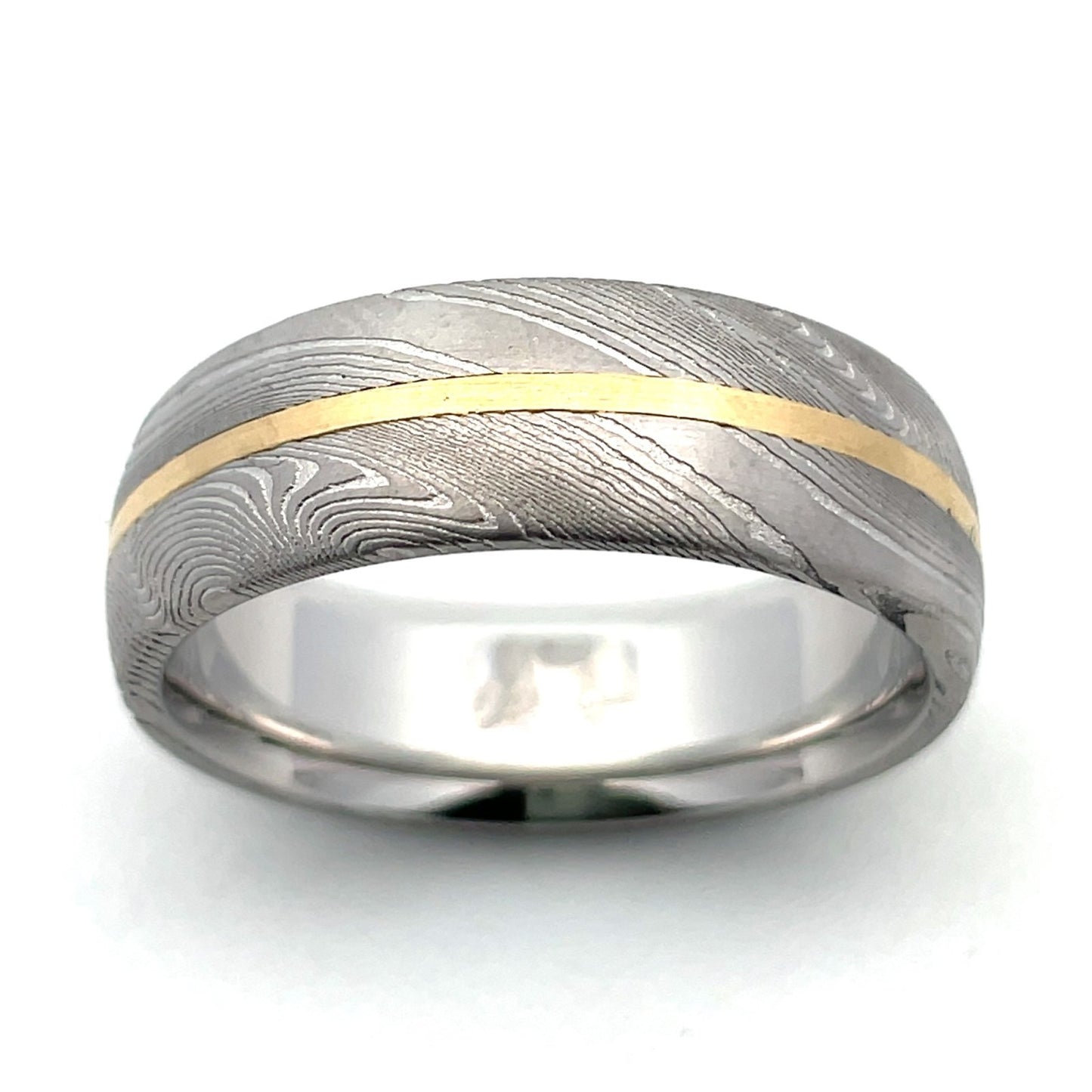 Two-tone gold ring with a Damascus steel inlay and a gold stripe, on a white background.