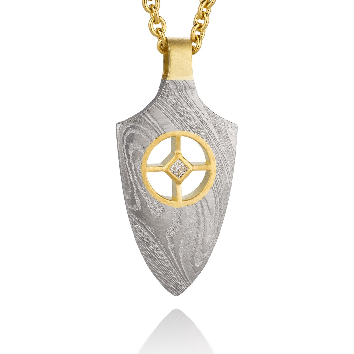 Gold shield-shaped Damascus necklace on a white background.