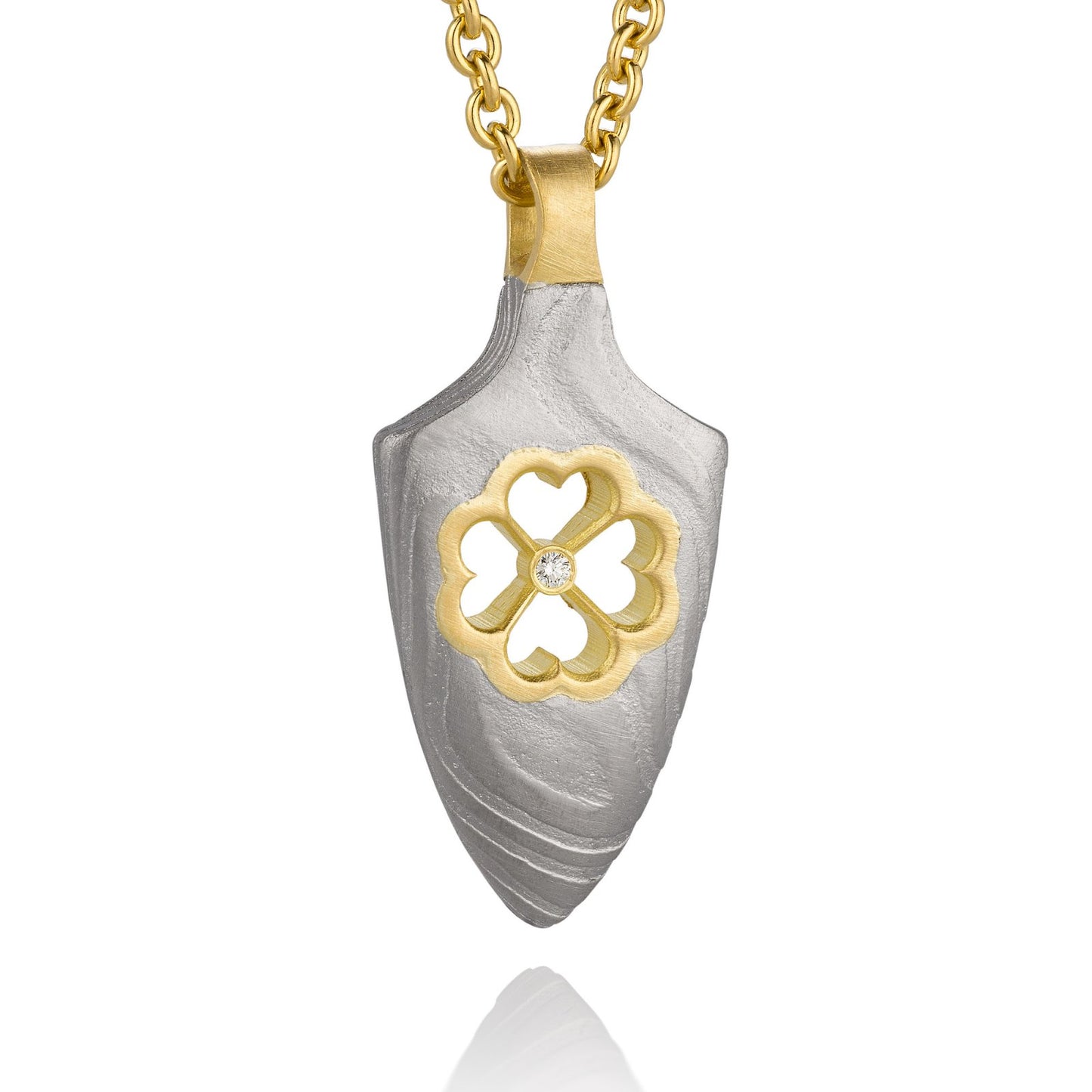 Gold shield-shaped Damascus necklace on a white background.