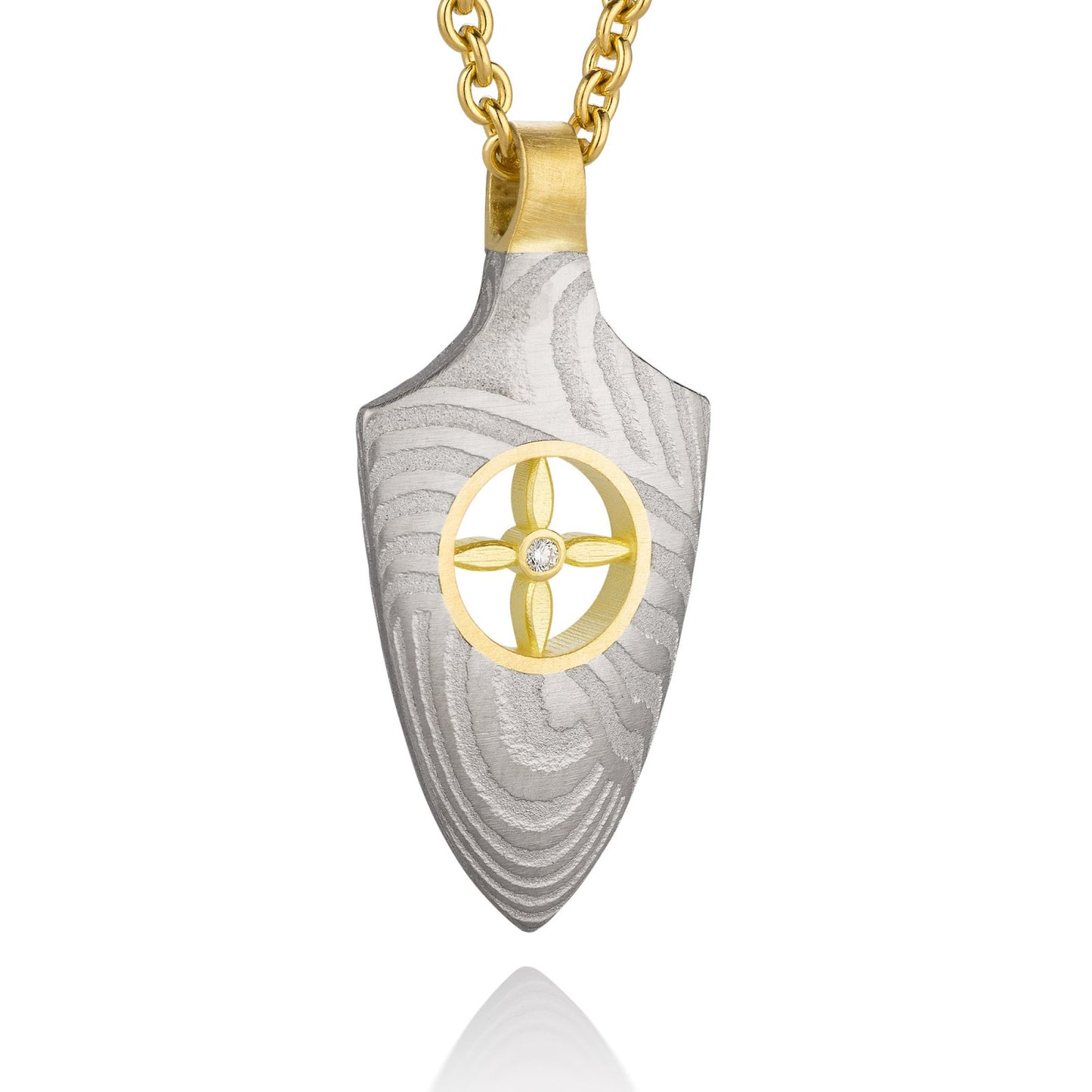 Gold shield-shaped Damascus necklace on a white background.