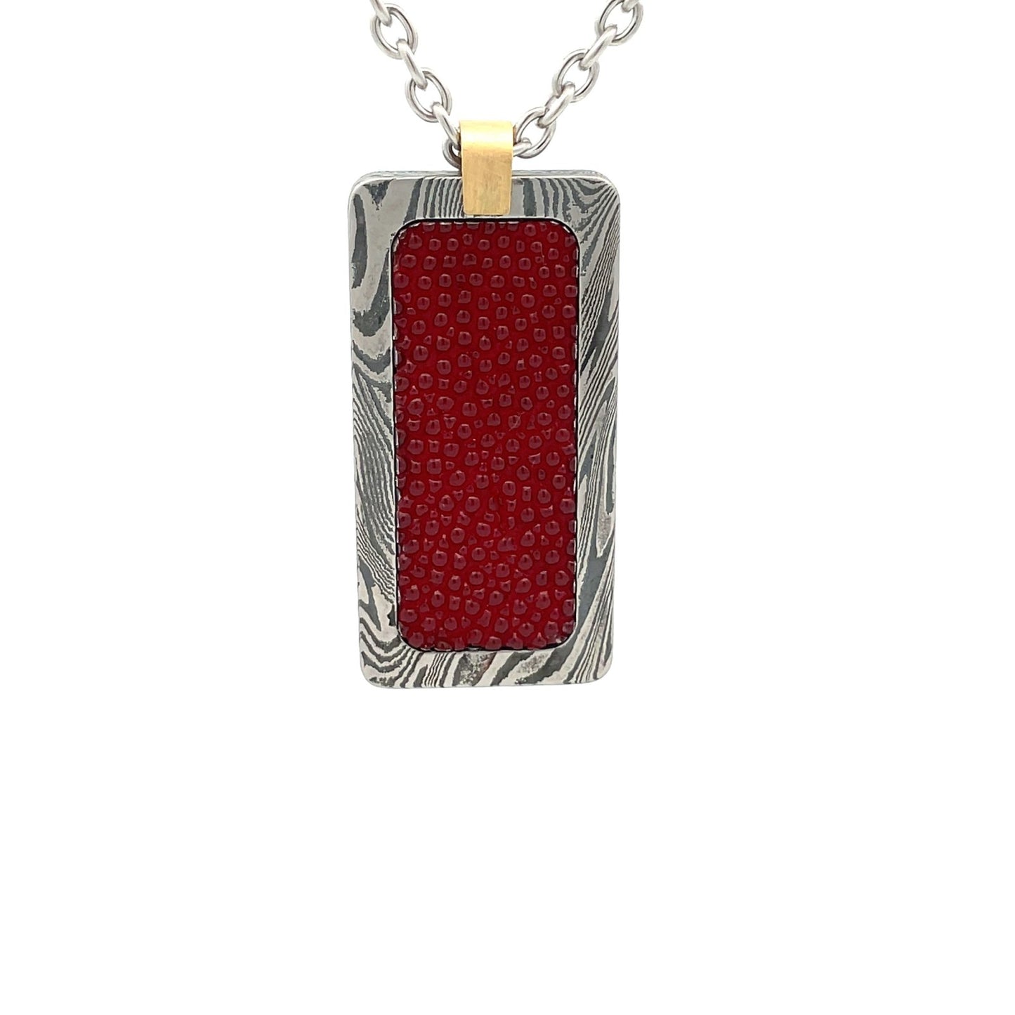 Silver rectangular pendant with a red center piece and a gold top, on a white background.