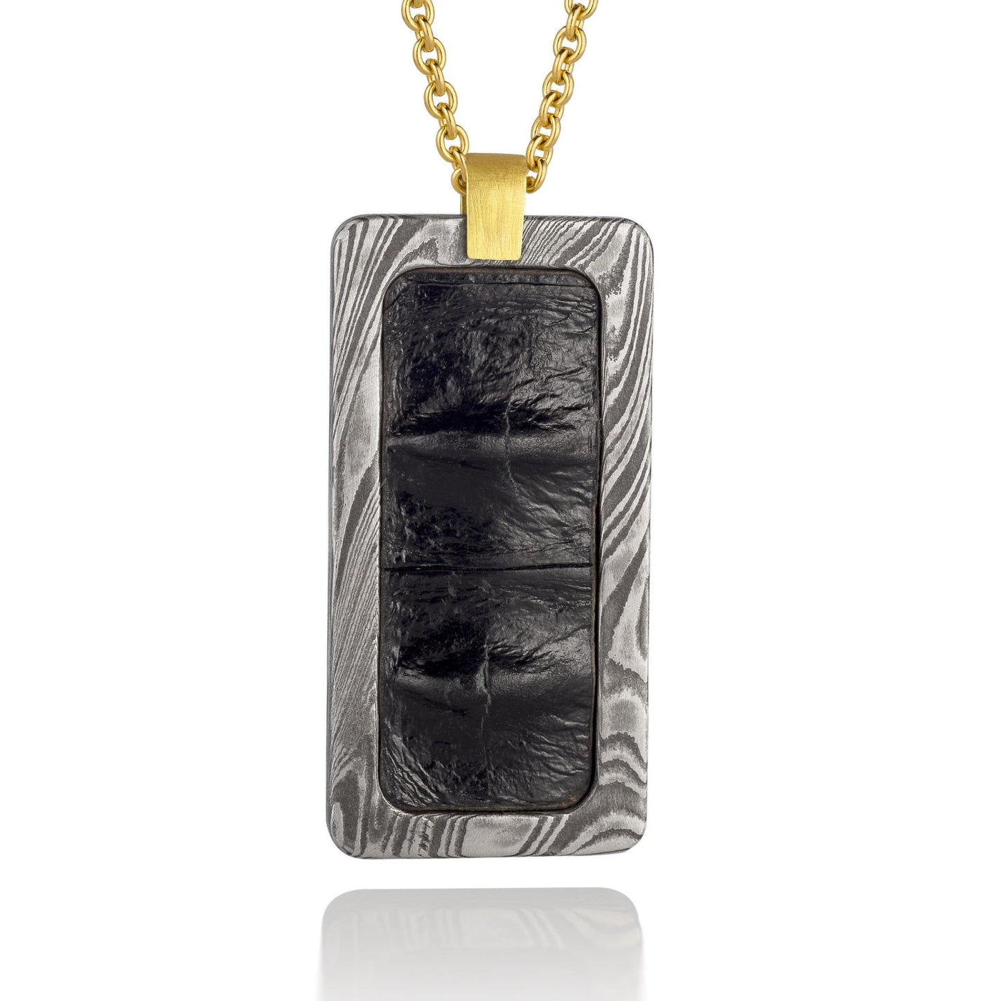 Silver rectangular pendant with a black center piece and a gold top, on a white background.