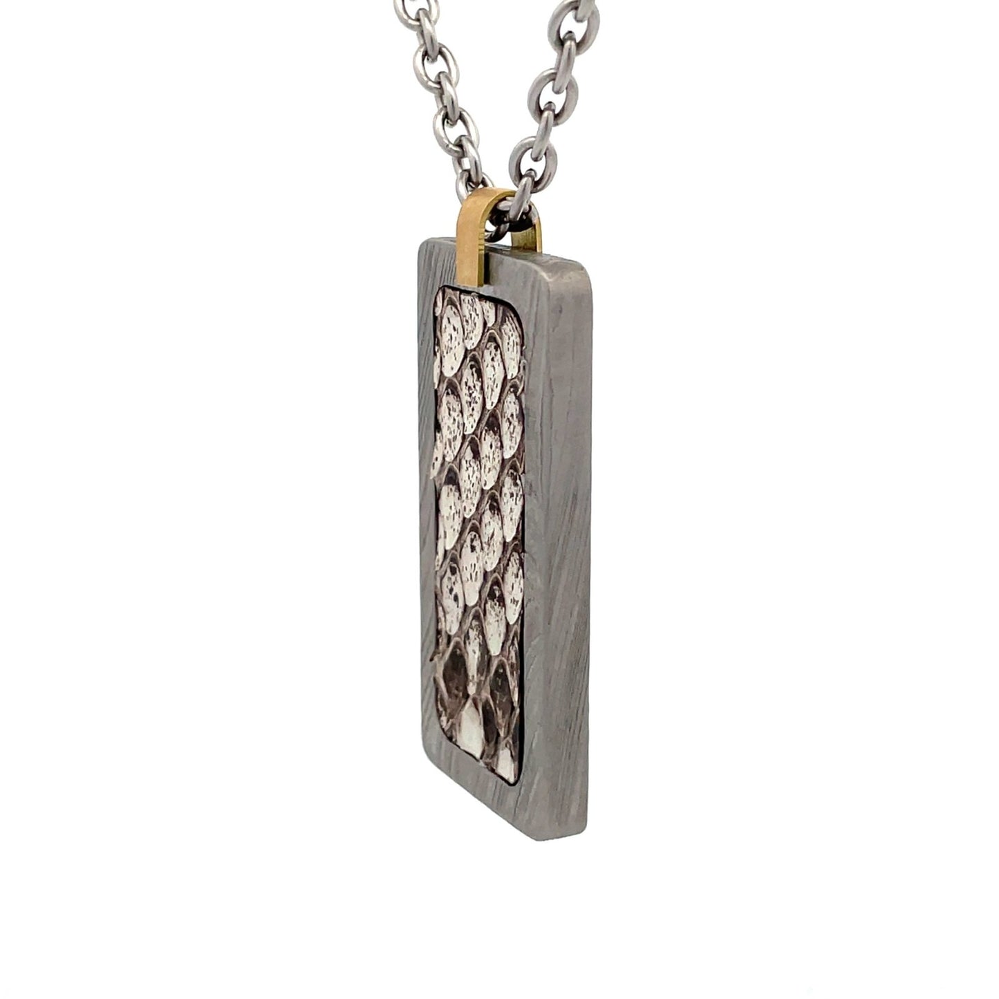Silver rectangular pendant with a white and black snake skin pattern in the center, on a white background.