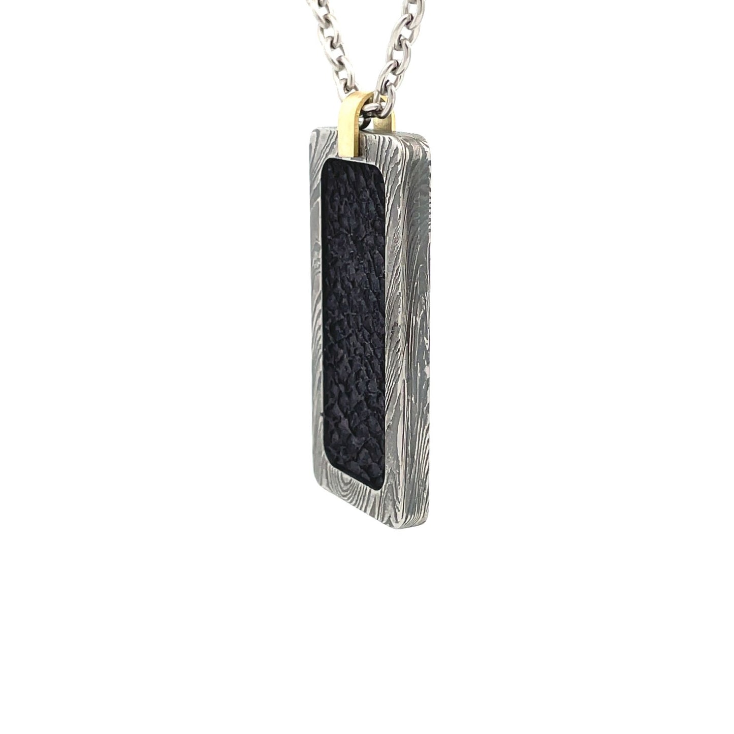 Silver rectangular pendant with a black center piece and a gold top, on a white background.*