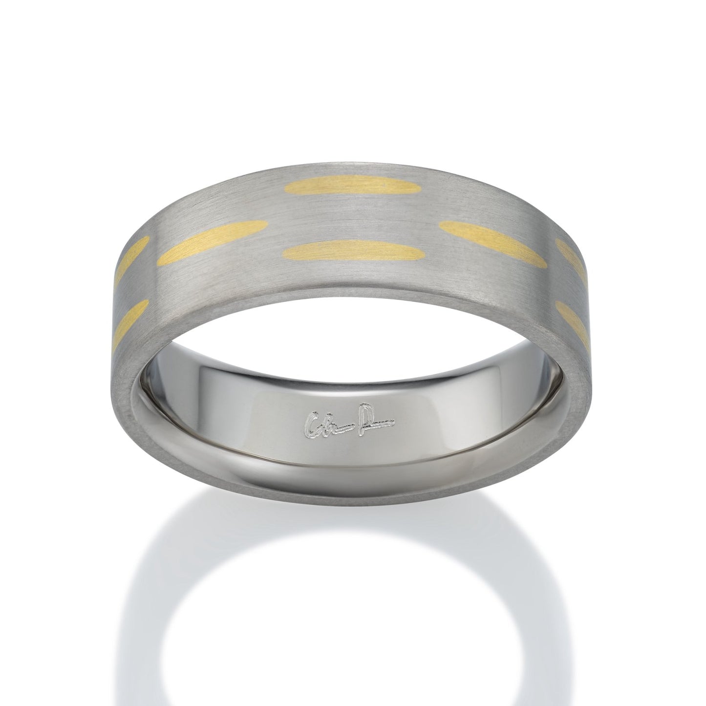 Two-tone silver and gold ring with a textured, striped pattern on a white backgroun