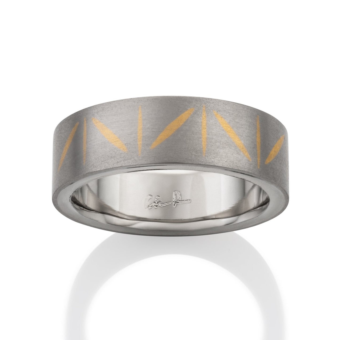 Two-tone tiatanium wedding band with a yellow gold inlay on a white background