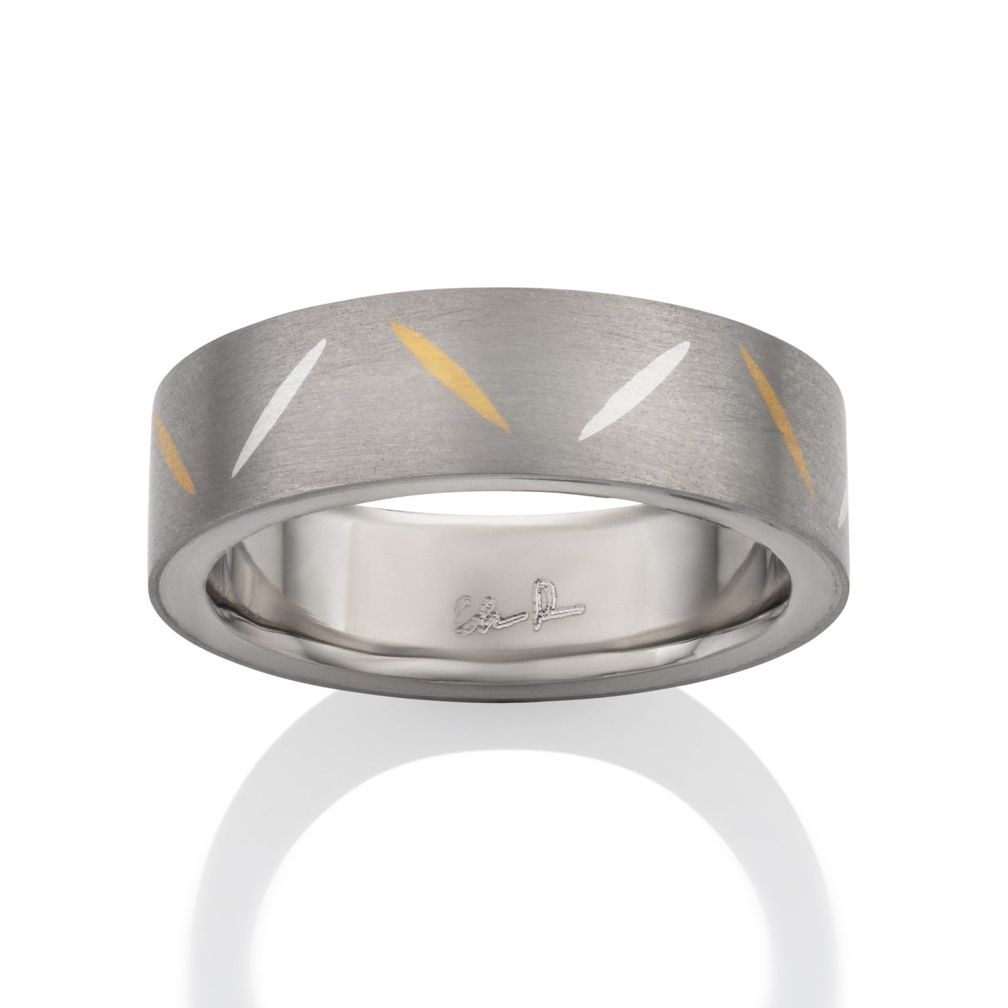 Two-tone tiatanium wedding band with a yellow gold inlay on a white background