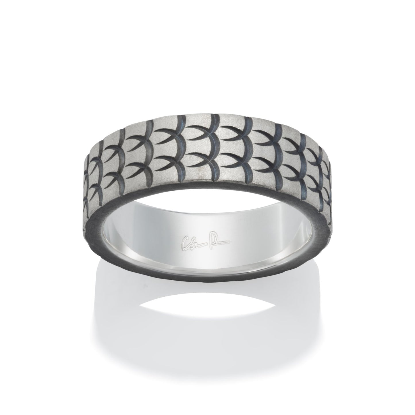 Dark gray silver ring with a textured, geometric pattern resembling fish scales, on a white background.