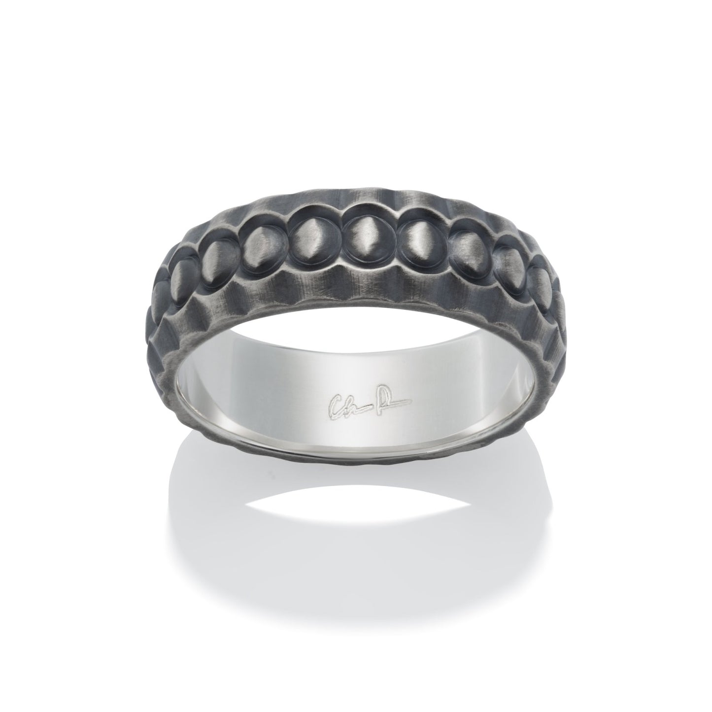 Dark gray silver ring with a textured, dome-shaped pattern resembling scales, on a white background.