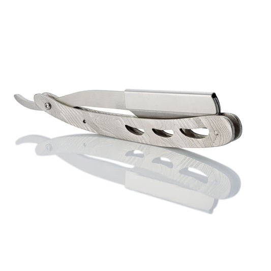 Stainless steel straight razor with a Damascus steel pattern on a white background.