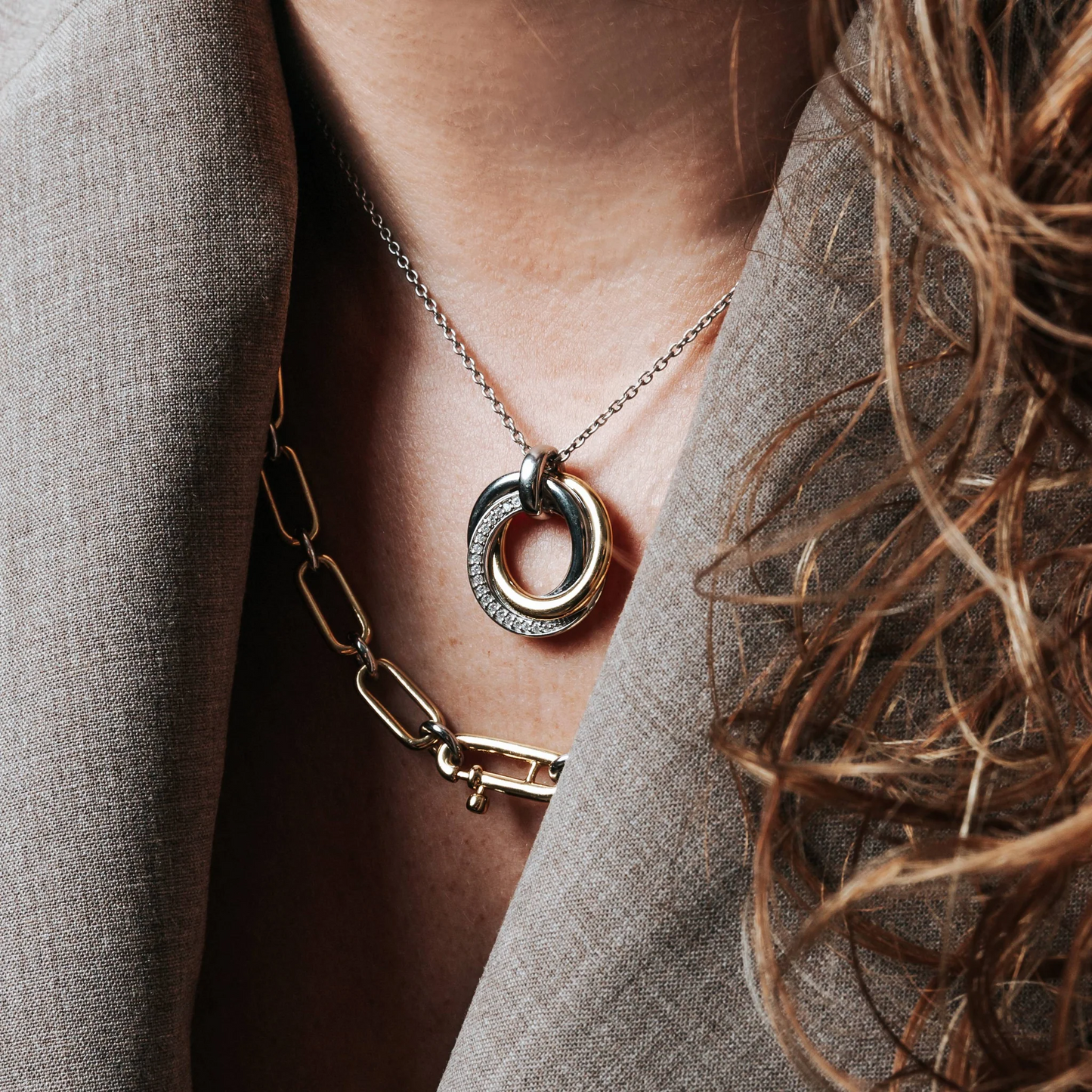 Necklace with a unique pendant worn by a person, close-up shot.