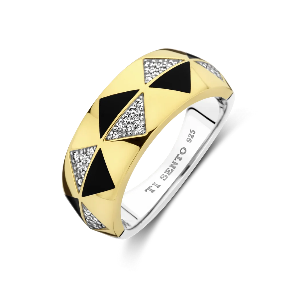 Gold and silver ring with black and diamond accents on a white background