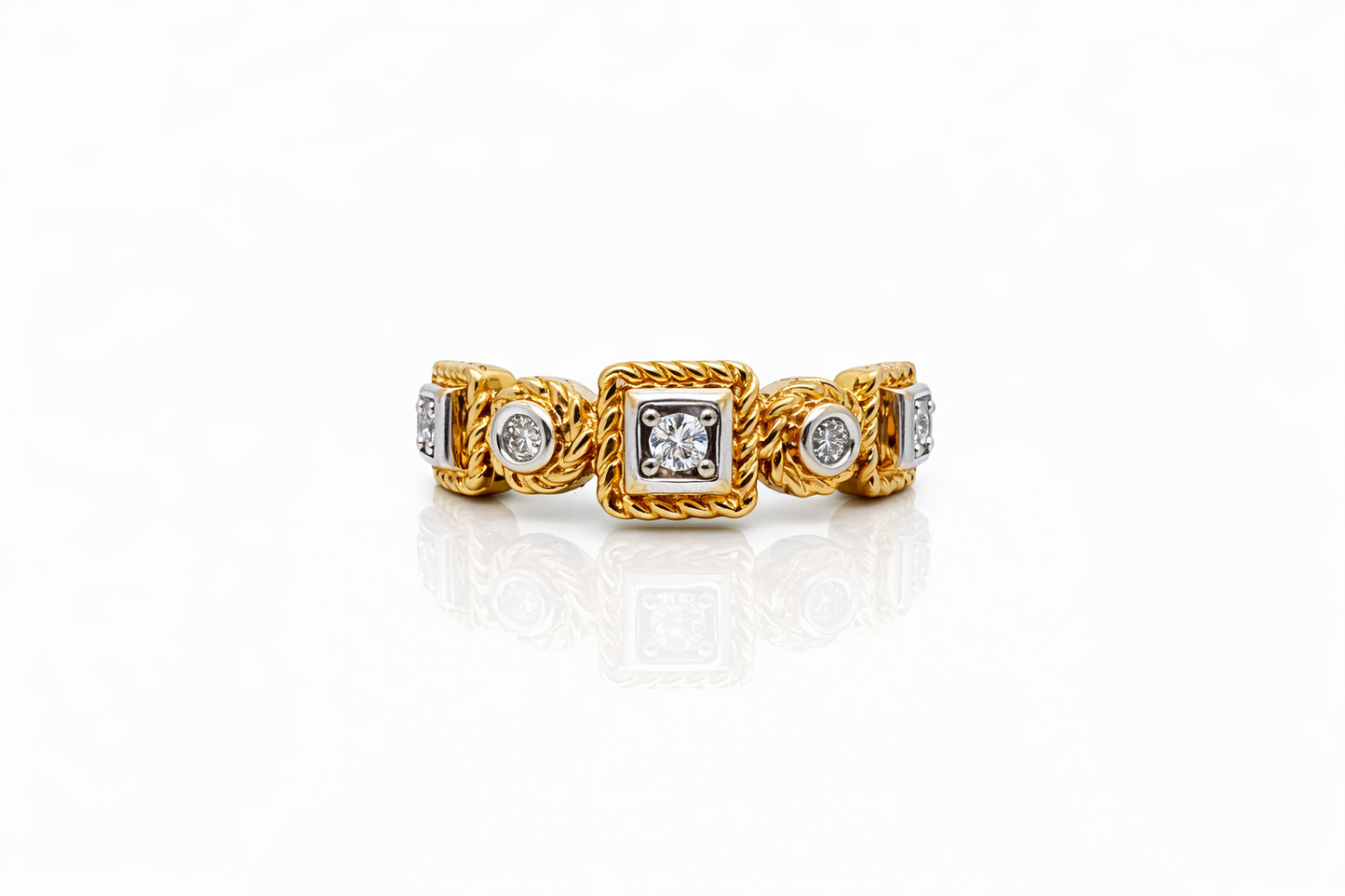Gold ring with diamond accents on a white background