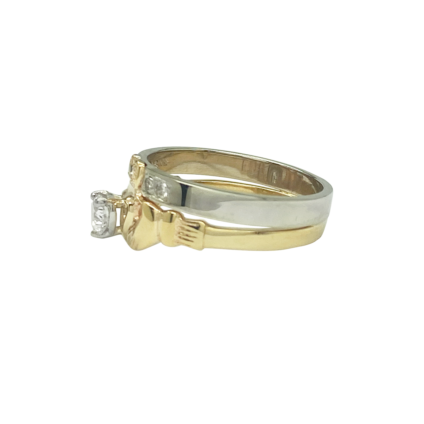 Two-tone gold diamond Claddagh ring set on a white backgorund