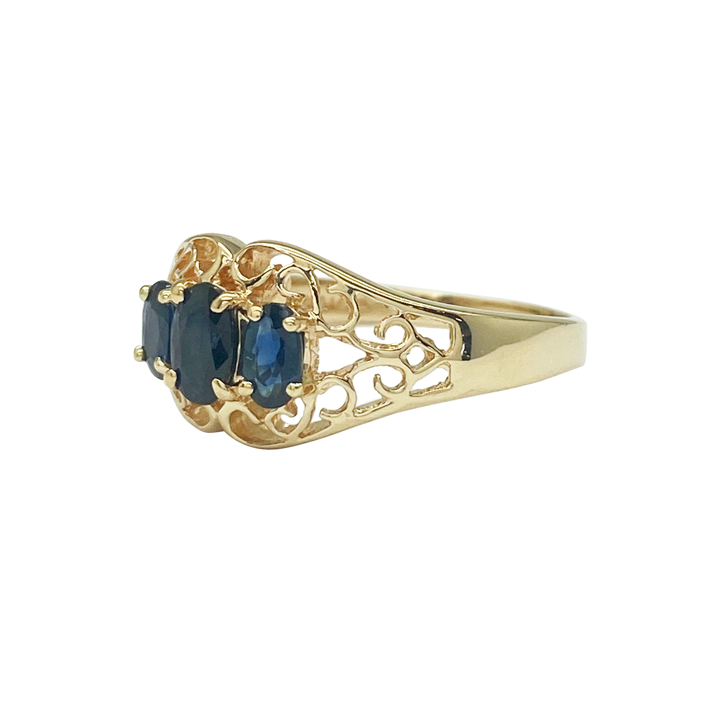 Yellow gold three-stone sapphire ring with filigree.