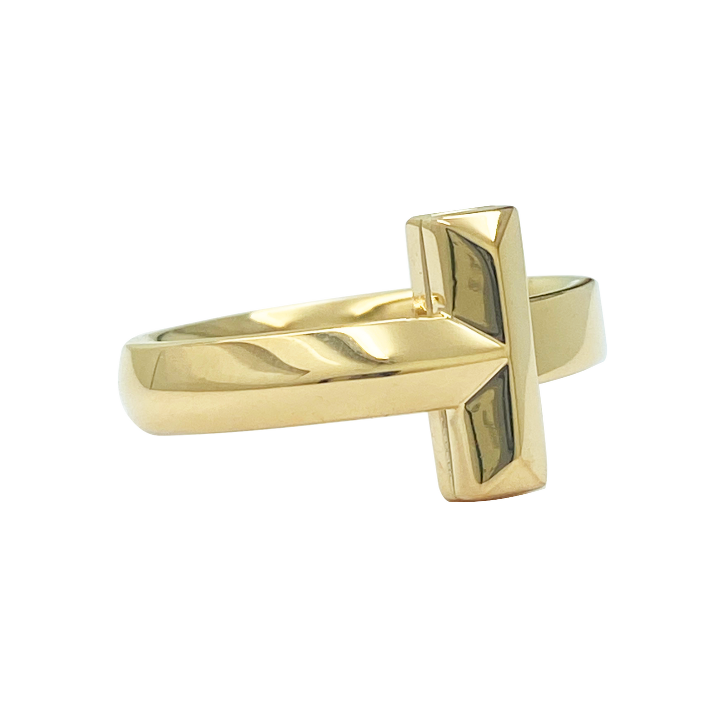 Gold ring with a geometric design on a white background