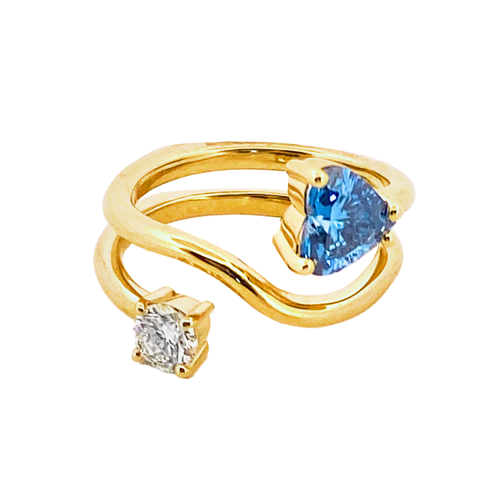 Gold ring features a heart-shaped blue sapphire and round white diamond.