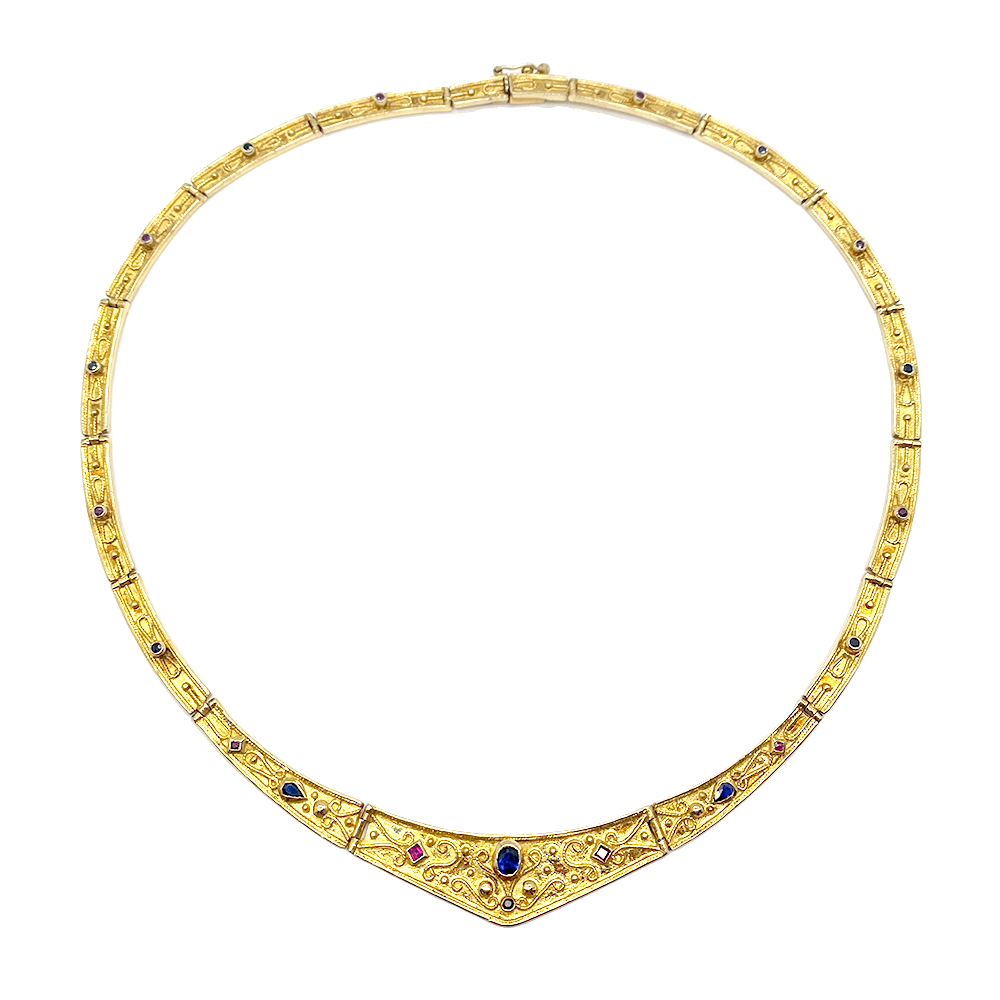 Byzantine gold necklace with precious stones, featuring a geometric pattern of rubies, sapphires, and emeralds set in a gold band. 