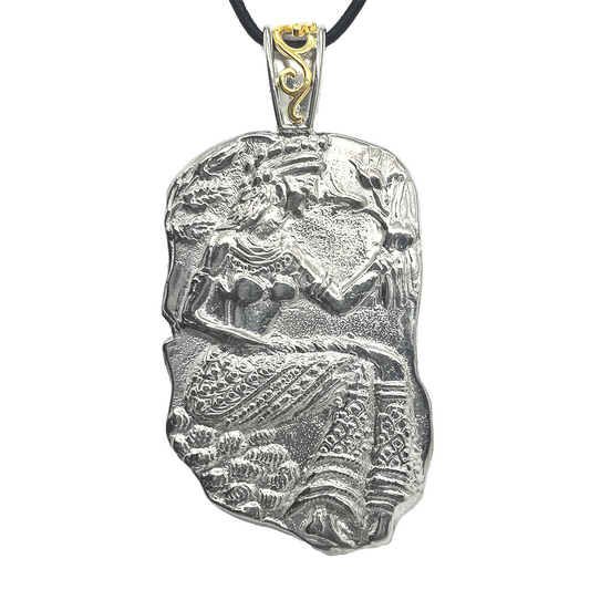 Silver pendant depicting a female figure, possibly a goddess, holding a jar or pitcher.