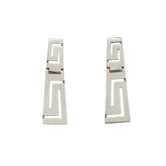 Silver earrings with a Greek key design. The background is white.
