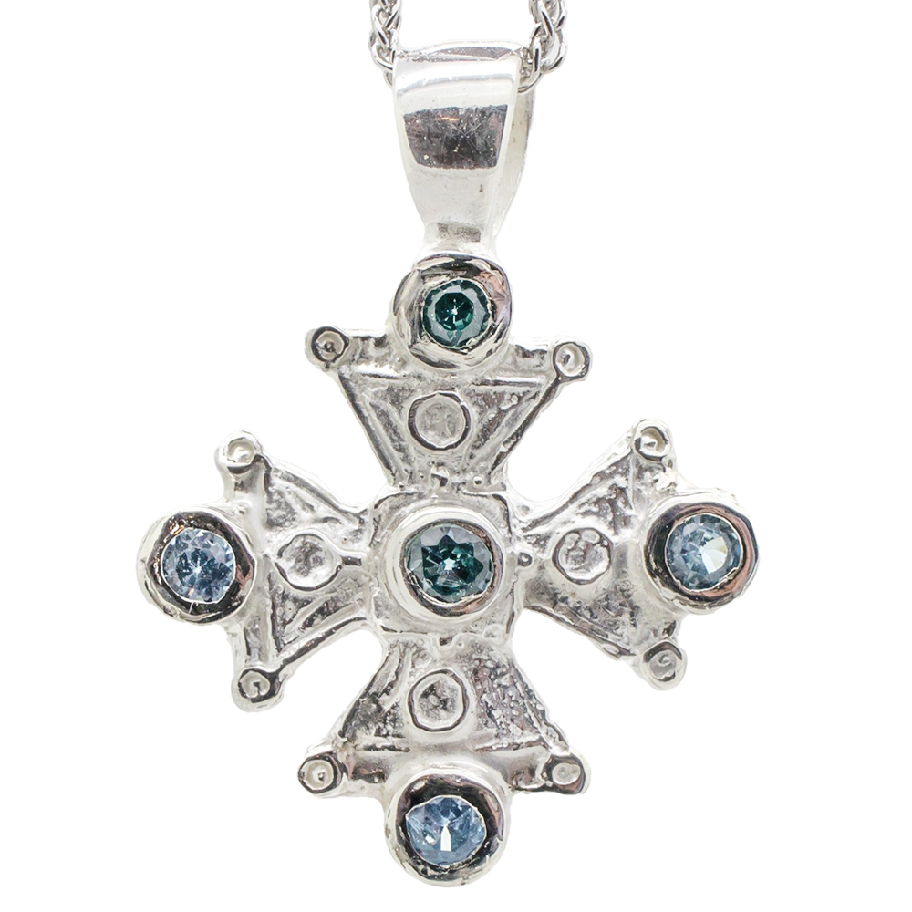 Silver cross pendant with gemstone.