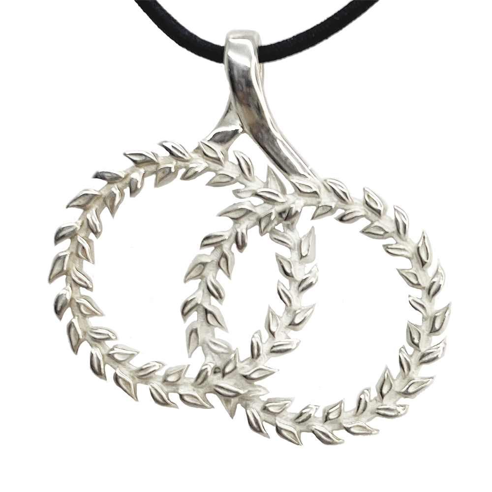 Silver pendant featuring two intertwined circles adorned with intricate leaf-like patterns.