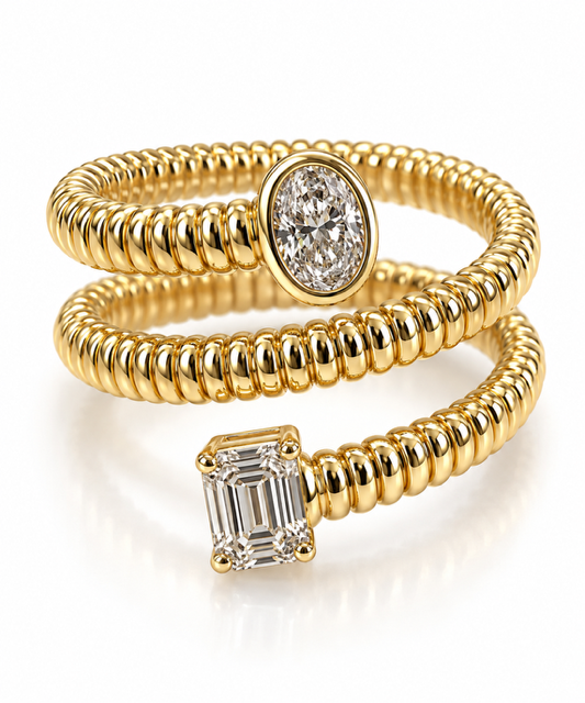 A gold snake-style ring with two oval diamond settings, one featuring an emerald-cut diamond and the other a round brilliant-cut diamond, on a clean white background.
