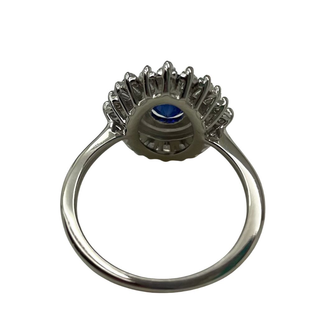 Silver ring with a blue gemstone on a white background
