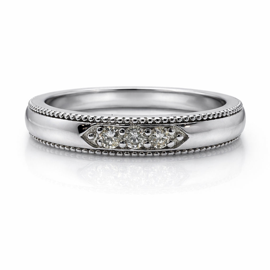 Silver ring with diamond accents on a white background