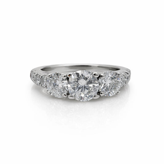 Diamond ring with three circular diamonds on a white background
