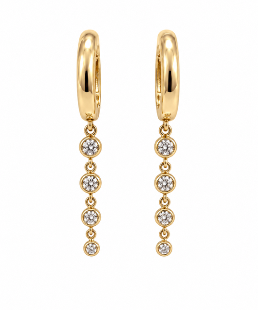 14k yellow gold huggie hoop earrings with a graduated drop of four bezel-set natural diamonds.