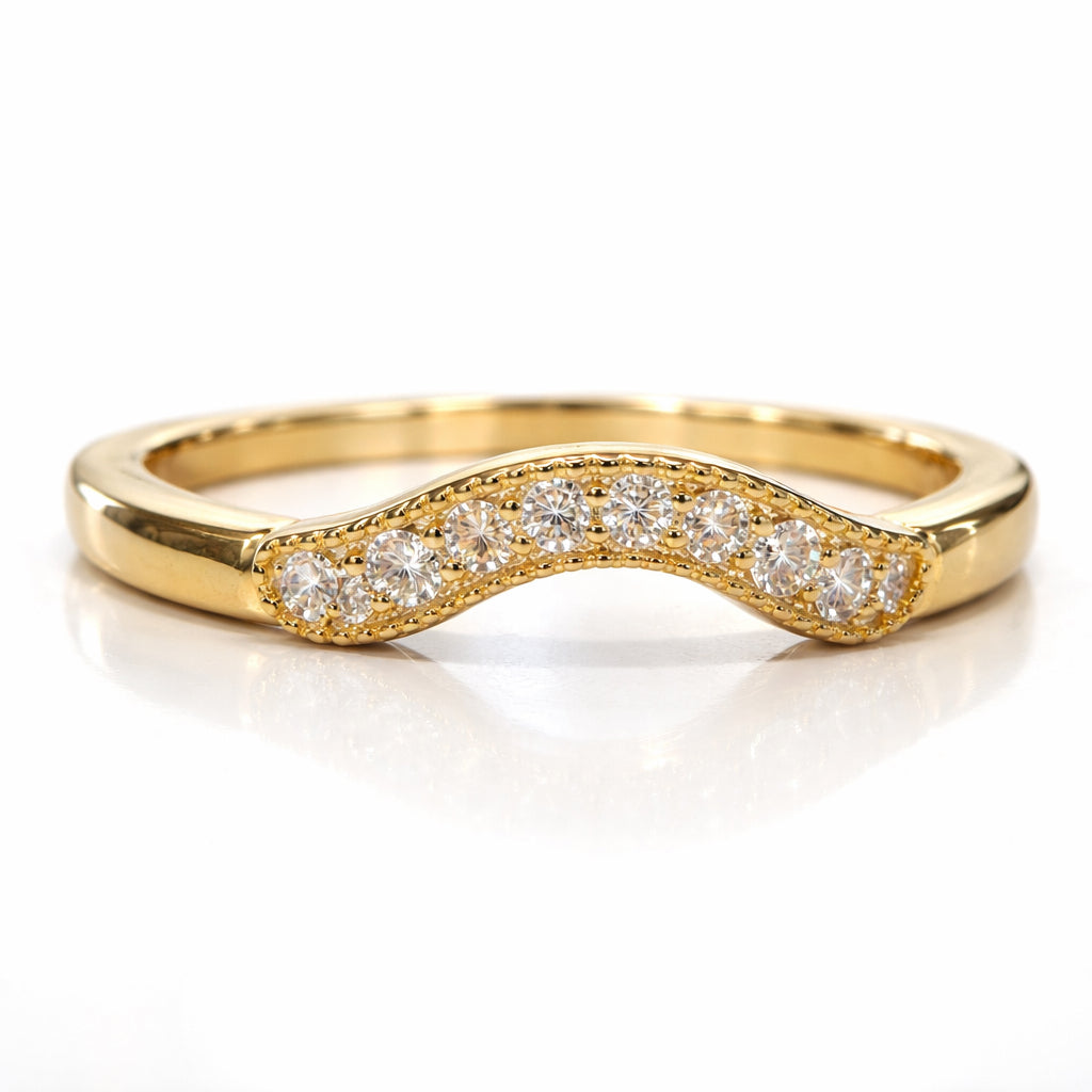Gold ring with diamond accents on a white background